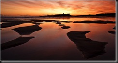 Neil_Maughan,_Dawn_over_Dunstanburgh
