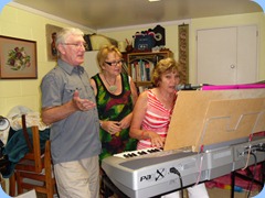 Gordon Sutherland and Jessyka Stuart singing along with Carole Littlejohn