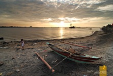 A Child Looks on as the Sun Sets at Bacolod's Bredco Port