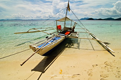 A Boat Docked at the Banol Beach in Coron