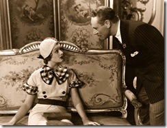 1932: Myrna Loy (1905 - 1993) looks up at Charles Ruggles (1886 - 1970), the American character comedian in a scene from 'Love Me Tonight', directed by Rouben Mamoulian for Paramount.