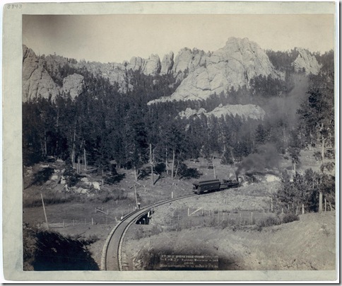 Title: "Horse Shoe Curve." On B[urlington] and M[issouri River] R'y. Buckhorn Mountains in background
Bird's-eye view of a train on tracks, just beyond a marked curve. 1891.
Repository: Library of Congress Prints and Photographs Division Washington, D.C. 20540