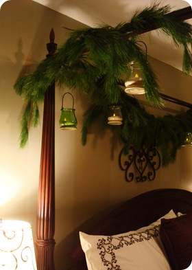 pine and candles hanging from bed canopy