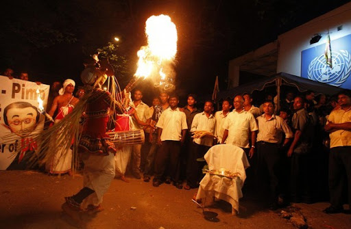 Protesters%20watch%20dancers%20perform%20a%20traditional%20devil%20dance.jpg
