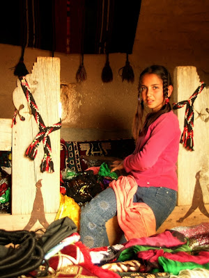 young Turkish girl near the path in Harran making handicrafts
