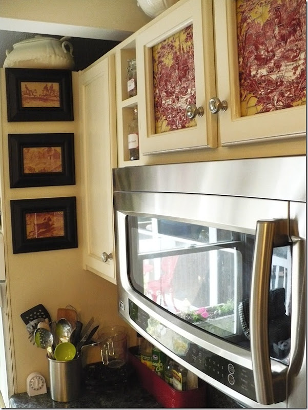 toile fabric framed in black frames in kitchen