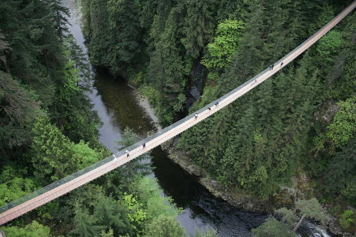 Capilano-Bridge-Vancouver-British-Columbia - Visitors walk across the Capilano Suspension Bridge above the Capilano River and surrounding rainforest in Vancouver.