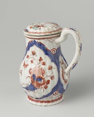 Melkkan van geribde veelkleurig beschilderde faïence met decor van hoorn van overvloed, gevuld met bloemen