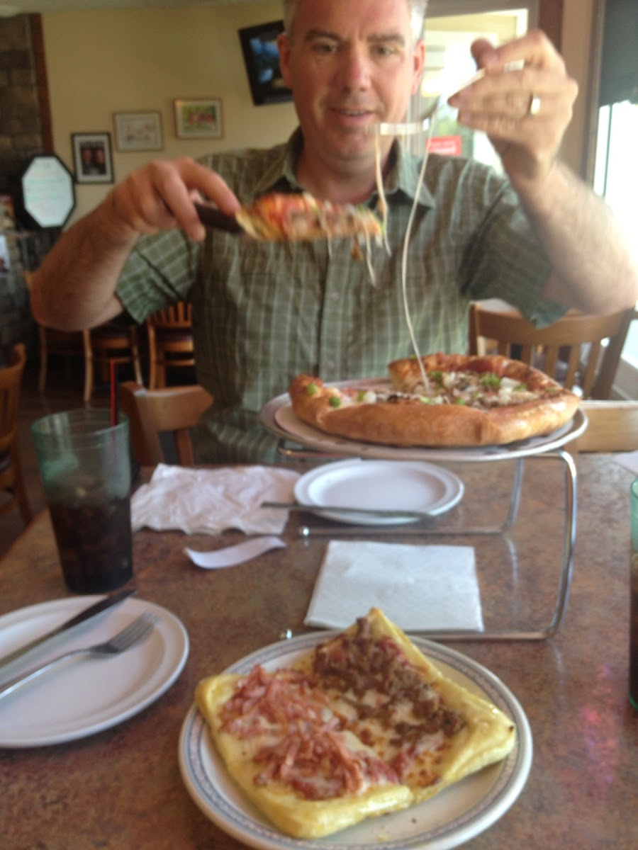 My GF pizza in front. My happy hubby with his pizza in the back.