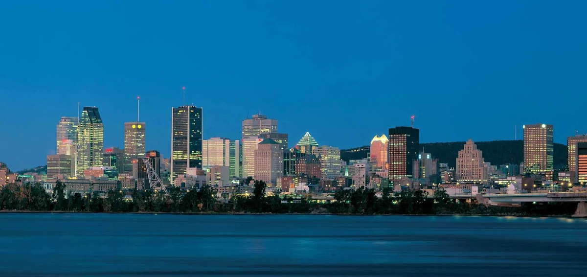 Montreal-skyline-at-dusk - The Montreal skyline over the St. Lawrence River at nightfall.