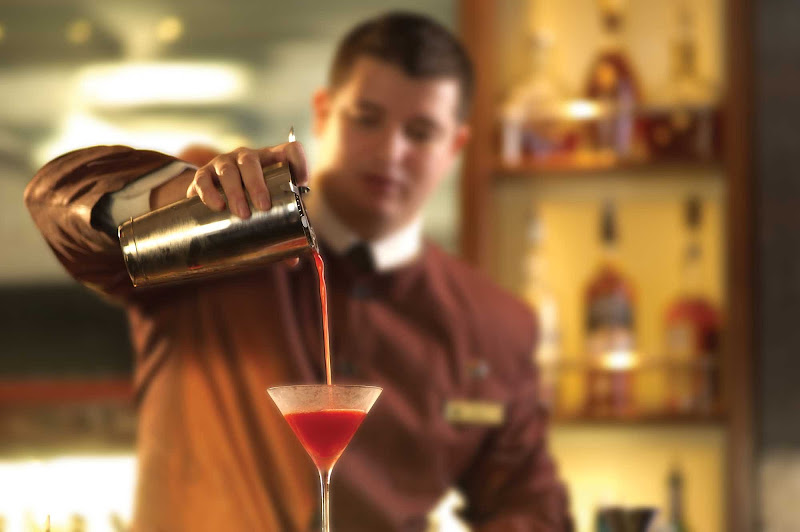 A crew member prepares a cocktail at the Commodore Club on Queen Mary 2.