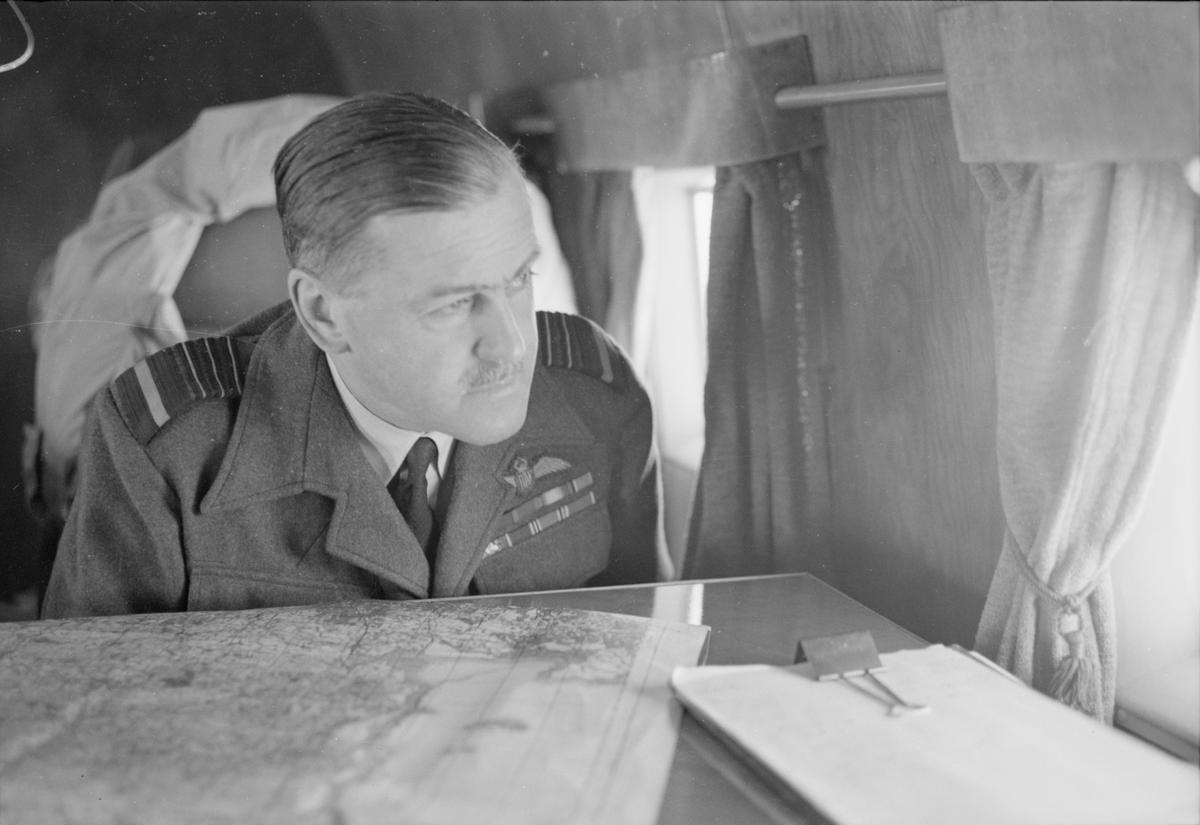 Air Chief Marshal Sir Trafford Leigh-Mallory, Commander-in-Chief of the Allied Expeditionary Air Force, looks down on Normandy from a Douglas Dakota aircraft, June 1944