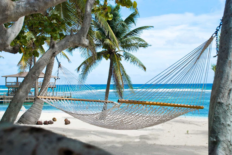 The Brac Reef Resort features hammocks on the beach of Cayman Brac.