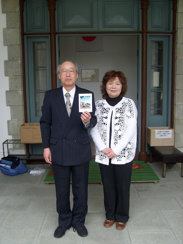 Master Ukon Tugue and his assistant outside the building.