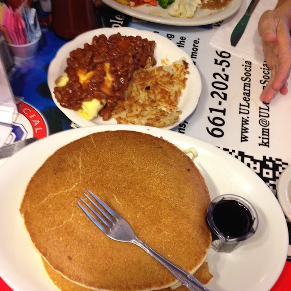 Stack of 3 GF Pancakes and in the background the absolutely silly hotdog chili omlette with hash bro