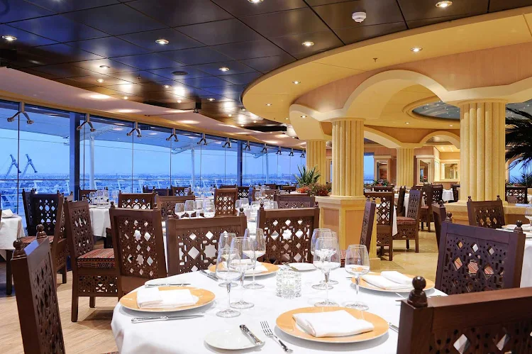 MSC Magnifica's L'Oasi Restaurant offers panoramic views of the passing landscapes and signature dishes designed by two-star Michelin chef Mauro Uliassi.