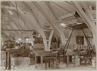 Interieur van een fabriekshal met werkbanken en aandrijfriemen voor machines