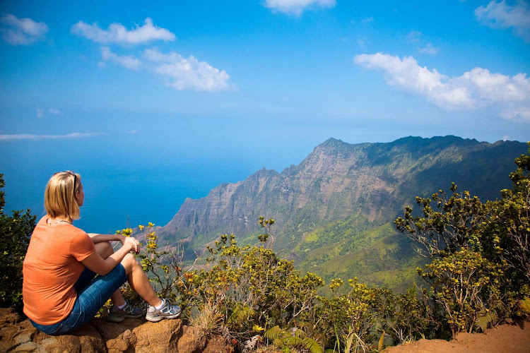 A woman takes in Kalalau Valley in Waimea, Kauai. 