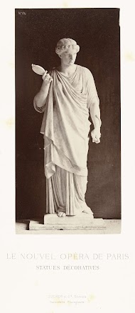 Marmeren beeld van een vrouw in een hooggesloten jurk met in haar rechterhand een spiegel, in de linkerhand een slang.