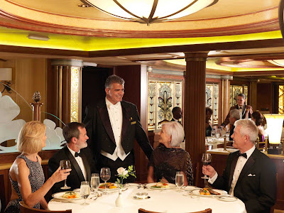 Diners and waiter at the Princess Grill aboard Queen Elizabeth.