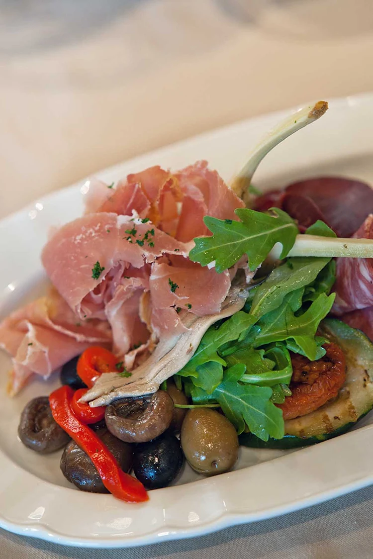 A charcuterie appetizer tray at Giovanni's Table aboard Oasis of the Seas, part of the Italian cuisine prepared under the direction of chef Marco Morrama.