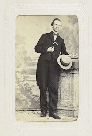 Studioportret van een man leunend tegen een pilaar