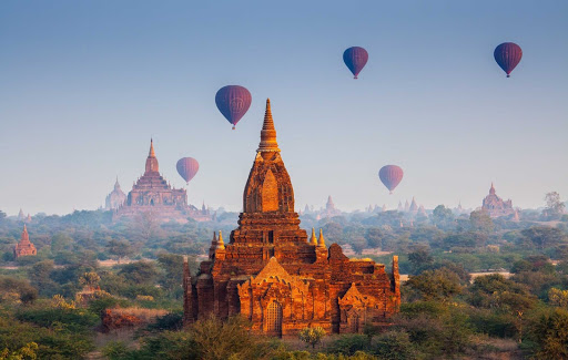 Myanmar-temples-and-hot-air-balloons - Hot air balloons hover above some 3,000 Buddhist temples during a sunrise flight in Bagan, Myanmar. You can now visit Bagan, Yangon, Mandalay and other breathtaking sites aboard AmaWaterways' luxury river cruise ship the AmaPura.