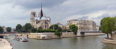 A river cruise ship sails past Notre Dame de Paris on Ile de la Cite in Paris.
 
