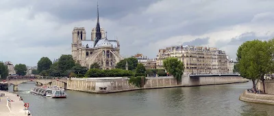 A river cruise ship sails past Notre Dame de Paris on Ile de la Cite in Paris.
 

