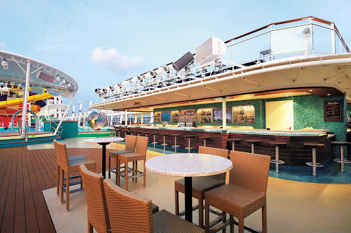 Norwegian-Epic-Waves-Bar - Relax on one of the Waves Pool Bar lounge chairs while sipping a cool drink. You're going to love life at sea. 
