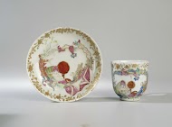 Bell-shaped cup and saucer with an erotic scene