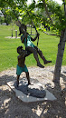 Children Swinging Statue at Museum