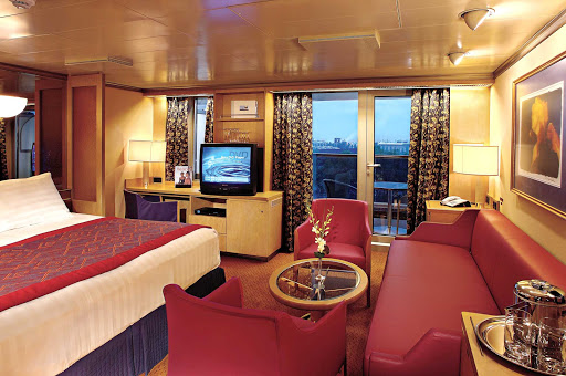 Holland-America-Vista-Class-Signature-Suite - A Signature Suite aboard your Holland America Line ship runs 273 to 456 square feet, which includes a private verdanda, one queen or two lower beds, bathroom with dual sink vanity, full-size whirlpool bath, sitting area and floor-to-ceiling windows.  