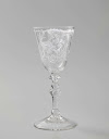 Wine glass with a woman at a spinet