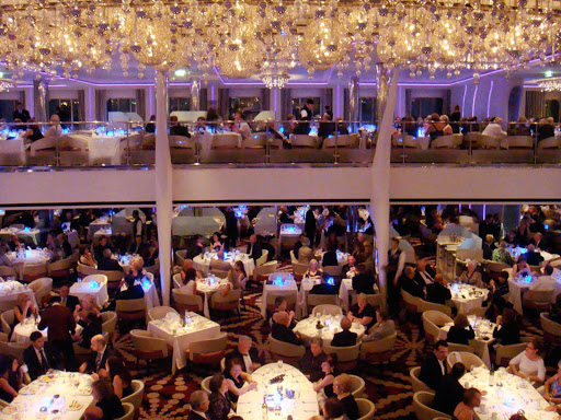 Celebrity-Equinox-night-dining - A side view of the main dining room on board Celebrity Equinox. 