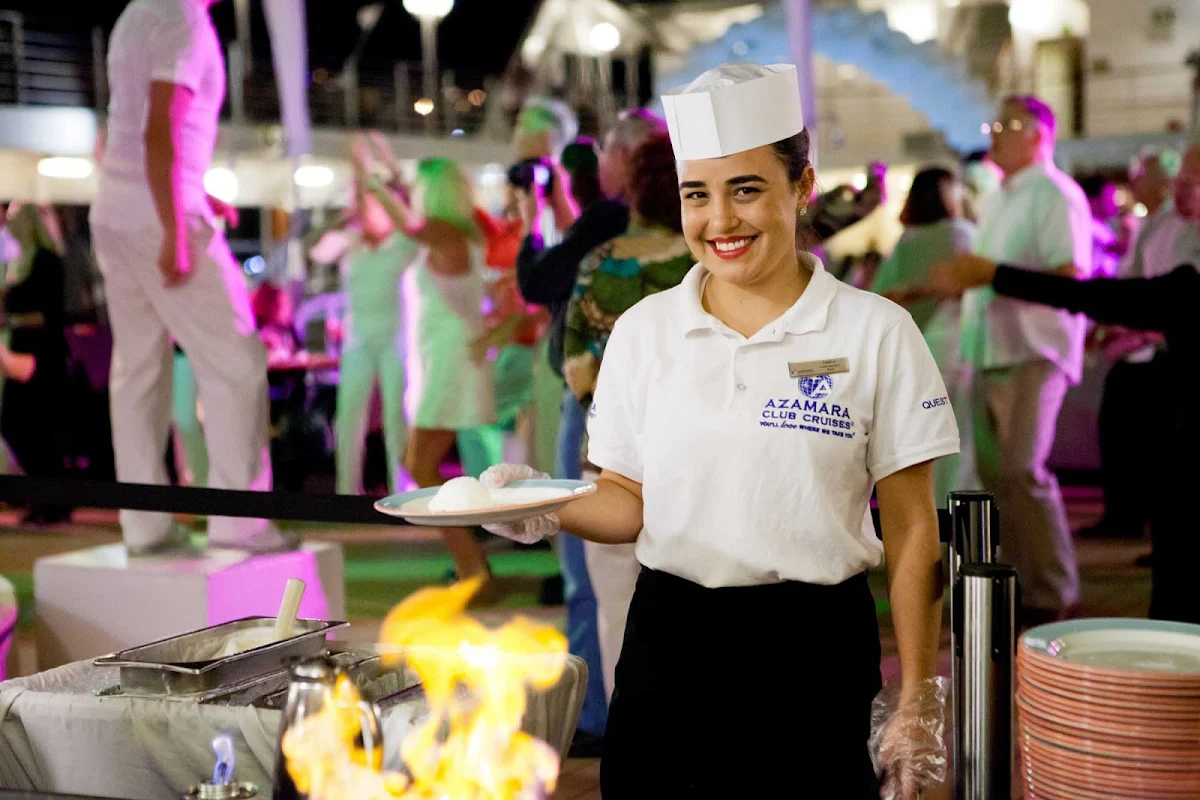 Azamara-White-Night-4 - An Azamara Club Cruises crew member serves up a dish during a White Night party.