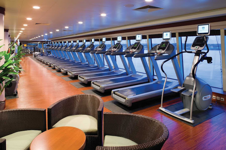 Work up a sweat while enjoying the floor-to-ceiling window view at Norwegian Pearl's Body Waves Fitness Center.