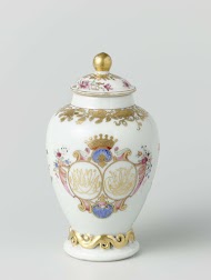 Ovoid tea caddy with handle from the 'Swellengrebel service' with a double crowned monogram and a border with floral scrolls