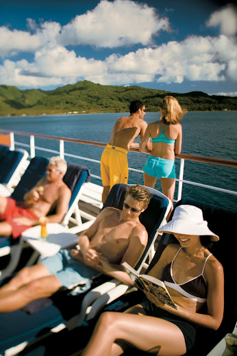 Bask in the Polynesian sunshine on the pool deck aboard the Paul Gauguin.