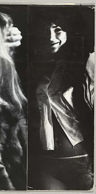 Glimlachende vrouw met lang donker haar, gekleed in een bloes